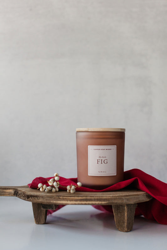 Fig scented 100% soy wax 10.5 oz candle in a beige frosted glass container