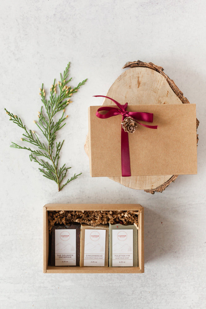 Three mini holiday soaps gift packaged in a festive holiday box