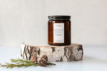Load image into Gallery viewer, Merry + Bright scented soy wax candle in amber jar with black lid