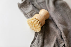 Natural sisal diswashing bamboo brush pictured with charcoal grey dishcloth